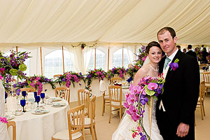 Anna and Ollie photographed in the marquee at their wedding reception